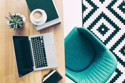 Overhead view of a Williams-Sonoma remote worker's home office, with stylish furniture and a laptop.