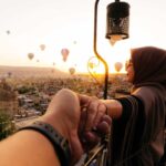 Rear View Of Woman Holding Man Hand during travel in cappadocia