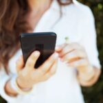 A woman using her smartphone to shop online.