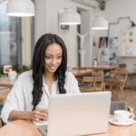 woman working in a cafe testing websites for cash