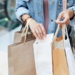A mystery shopper looking through shopping bags.