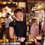 Landlady greets regular at real ale pub