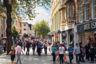 Queen Street, one of Cardiff's main shopping streets, busy with Saturday shoppers.