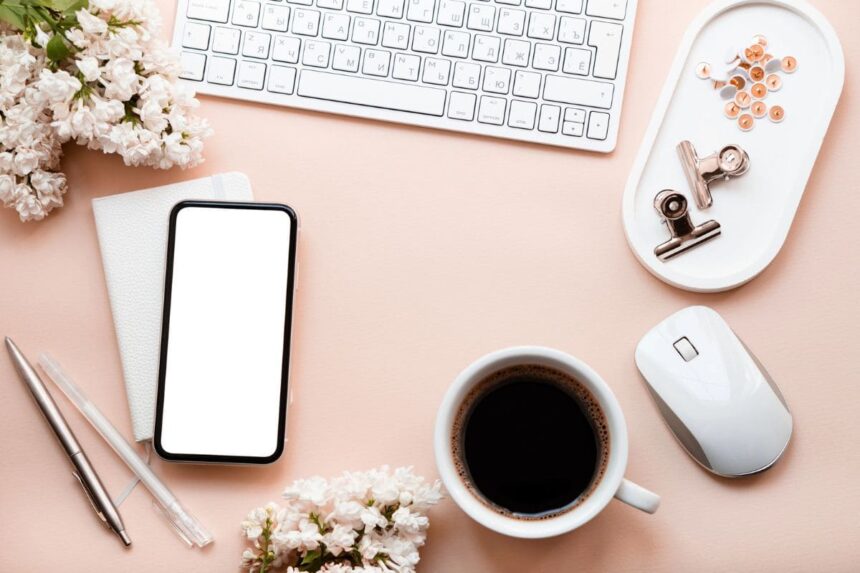 Overhead image of wedding flowers and accessories on a remote worker's desk.