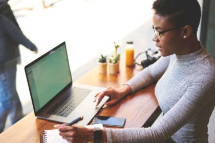 A woman working on her laptop in a cafe.
