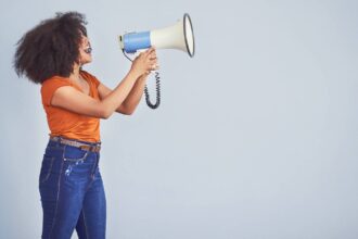 Black woman using loudspeaker to be heard