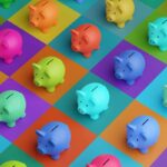 Array of piggy banks in saturated colours on high colour contrast background